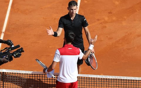 Thiem shakes hands with Djokovic - Credit: AFP