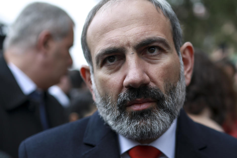 Acting Armenian Prime Minister Nikol Pashinian speaks to the media as he leaves a polling station during an early parliamentary election in Yerevan, Armenia, Sunday, Dec. 9, 2018. The charismatic 43-year-old Nikol Pashinian took office in May after spearheading massive protests against his predecessor's power grab that forced the politician to step down. (Vahan Stepanyan, PAN Photo via AP)