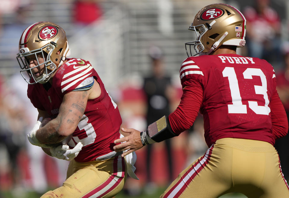 SANTA CLARA, CALIFORNIA - OCTOBER 01: Brock Purdy #13 of the San Francisco 49ers hands off to Christian McCaffrey #23 against the Arizona Cardinals in the fourth quarter of an NFL football game at Levi's Stadium on October 01, 2023 in Santa Clara, California. (Photo by Thearon W. Henderson/Getty Images)