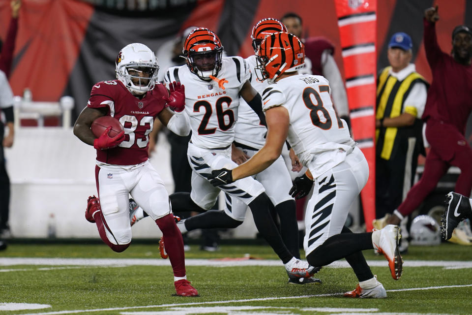 Arizona Cardinals' Greg Dortch (83) runs on a punt return, as Cincinnati Bengals' Justin Rigg (87) prepares to make the tackle during the second half of an NFL football preseason game in Cincinnati, Friday, Aug. 12, 2022. (AP Photo/Michael Conroy)