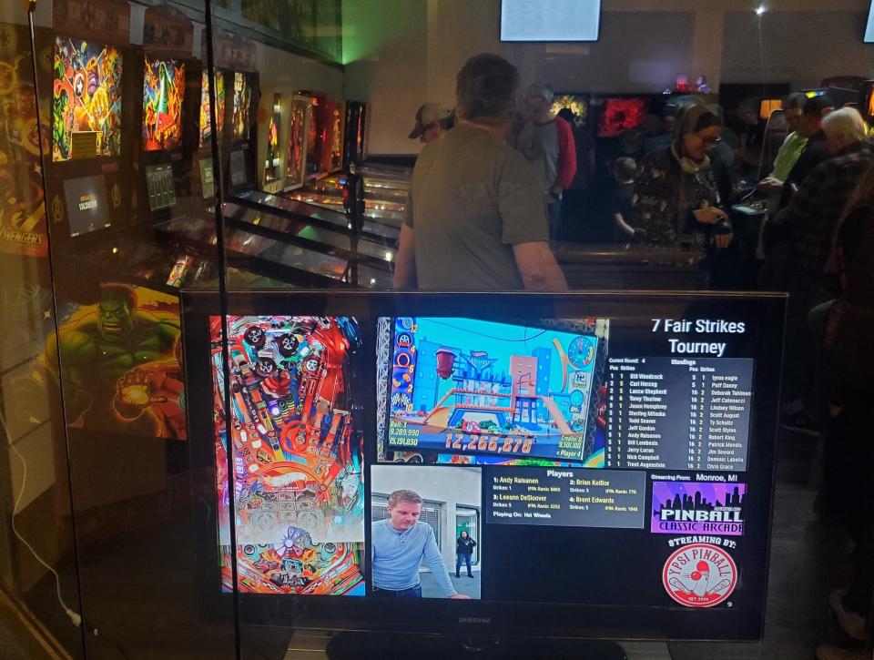 As players competed at the annual Holiday Extravaganza pinball tournament sponsored by ULEKstore’s Pinball and Classic Arcade inside the Mall of Monroe, scores were posted for everyone to view.