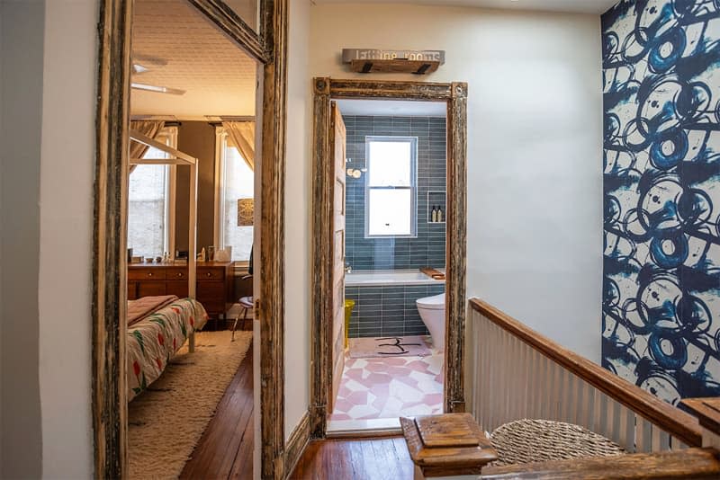 View into bathroom and bedroom from hallway.