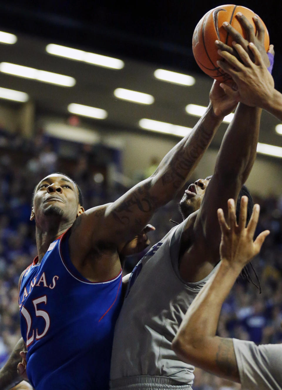 Kansas forward Tarik Black (25) battles for a rebound against Kansas State forward D.J. Johnson (50) during the first half of an NCAA college basketball game in Manhattan, Kan., Monday, Feb. 10, 2014. (AP Photo/Orlin Wagner)