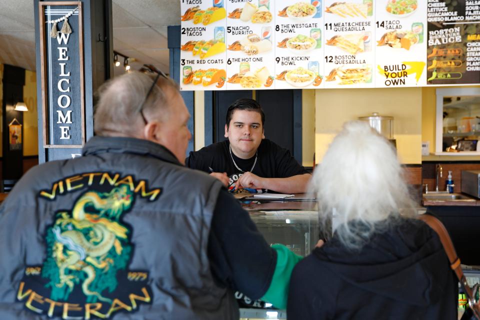 Jack Fernandes, co-owner, takes a customer's order at the new Boston Burrito on Rockdale Avenue in New Bedford.