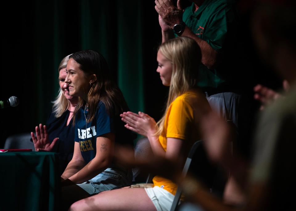 Liz Nguyen, a senior at A. Crawford Mosley High School in Lynn Haven, Fla., signs her letter of intent April 17, 2024, to continue her education and cheer career at Warner University. (Tyler Orsburn/News Herald)