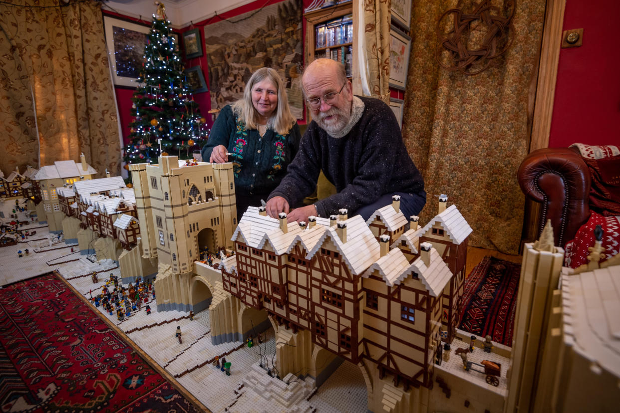 Mike Addis ,63 and wife Catherine Weightman, 58 with their lego display for this Christmas that is of Old London Bridge frost fair. (SWNS)