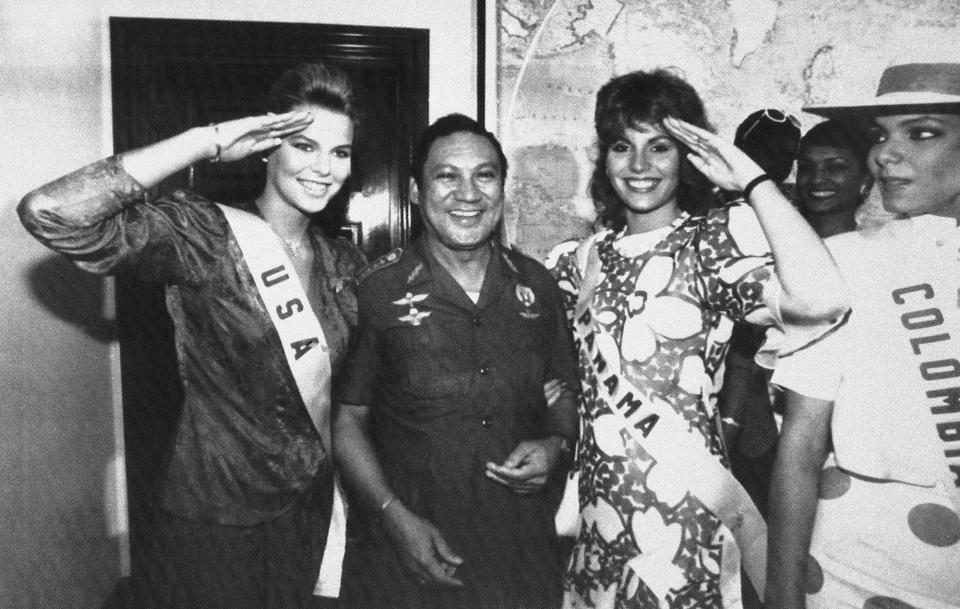 <p>Miss USA Christy Fichtner, left, and Miss Panama Gilda Garcia Lopez, salute while flanking Gen. Manuel Antonio Noriega in Panama City on July 5, 1986. Pictured at right is Miss Colombia Maria Monica Urbina. (AP Photo/Jim Ellis) </p>