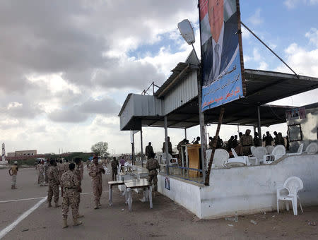 Soldiers inspect the scene of a Houthi drone attack at Yemeni government military parade in al-Anad air base, Lahaj province, Yemen January 10, 2019. REUTERS/Stringer