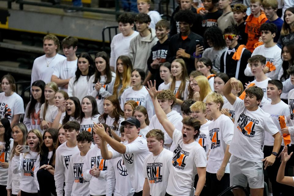 The Marlington Dukes student section cheers in the second set Thursday.