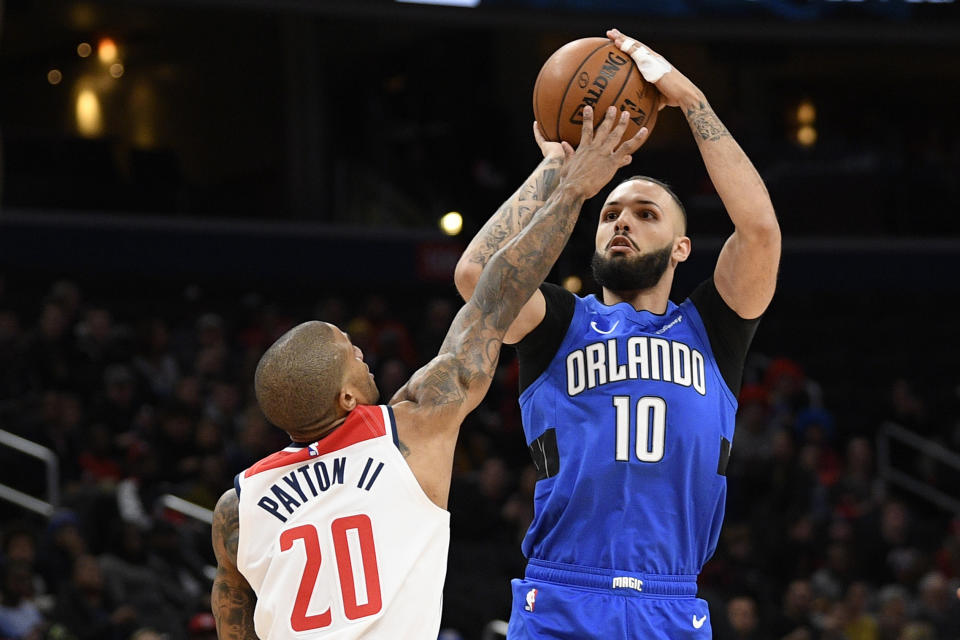 Orlando Magic guard Evan Fournier (10) shoots as Washington Wizards guard Gary Payton II (20) defends during the first half of an NBA basketball game Wednesday, Jan. 1, 2020, in Washington. (AP Photo/Nick Wass)