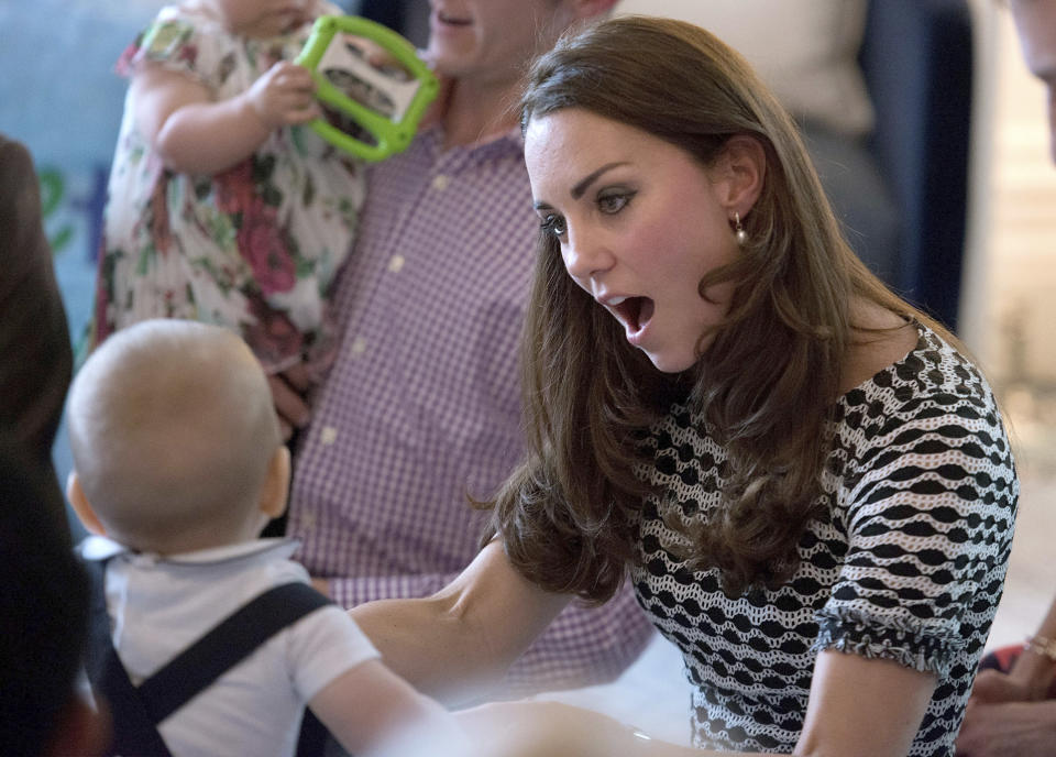 Britain's Prince George, left, plays with his mother, Kate, the Duchess of Cambridge, during a visit to Plunket nurse and parents group at Government House in Wellington, New Zealand, Wednesday, April 9, 2014. Plunket is a national not-for-profit organization that provides care for children and families in New Zealand. Britain's Prince William, Kate and their son, Prince George, are on a three-week tour of New Zealand and Australia. (AP Photo/Marty Melville, Pool)