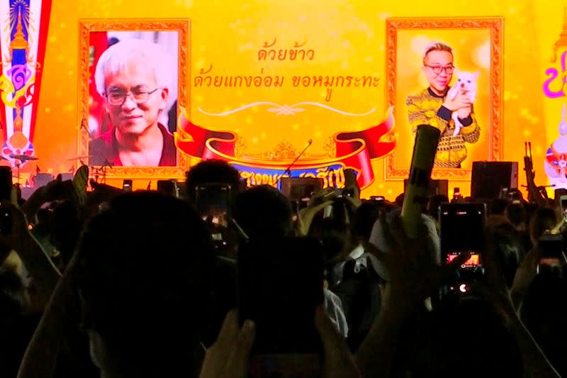 A still image from a video shows images of Somsak and Pavin at a demonstration in Bangkok