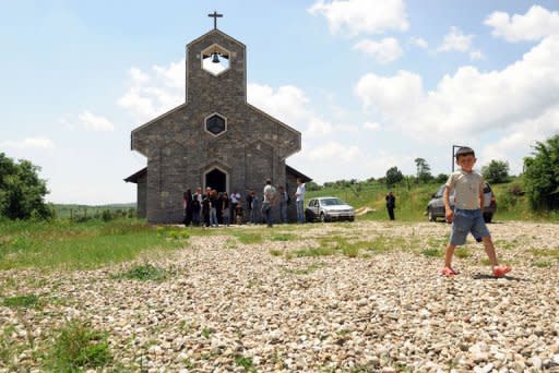 Catholic villagers gather in front of the church in the village of Kravaseri. Only about 50,000 of Kosovo's 1.7 million citizens are Catholics, while more than 90 percent of the population are Muslim