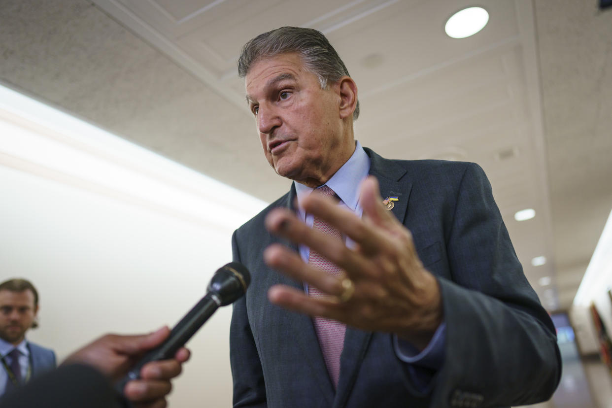 Sen. Joe Manchin, D-W.Va., is met by reporters outside the hearing room where he chairs the Senate Committee on Energy and Natural Resources, at the Capitol in Washington, Tuesday, July 19, 2022. (J. Scott Applewhite/AP)