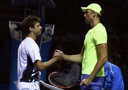 Tennis - Australian Open - Melbourne Park, Melbourne, Australia - 17/1/17 Croatia's Ivo Karlovic (R) shakes hands after winning his Men's singles first round match against Argentina's Horacio Zeballos. REUTERS/Thomas Peter