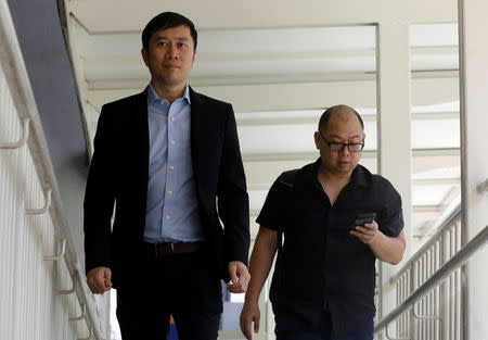 Human rights activist Jolovan Wham (L) arrives at the State Court in Singapore February 21, 2019. REUTERS/Edgar Su