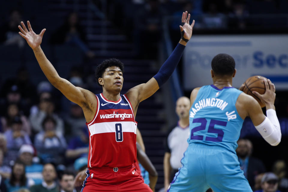 Washington Wizards forward Rui Hachimura (8) defends against Charlotte Hornets forward P.J. Washington in the first half of an NBA basketball game in Charlotte, N.C., Tuesday, Dec. 10, 2019. (AP Photo/Nell Redmond)