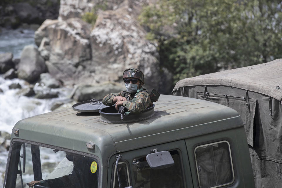 An Indian army soldier keeps guard on top of his vehicle as their convoy moves on the Srinagar- Ladakh highway at Gagangeer, northeast of Srinagar, Indian-controlled Kashmir, Tuesday, Sept. 1, 2020. India said Monday its soldiers thwarted “provocative” movements by China’s military near a disputed border in the Ladakh region months into the rival nations’ deadliest standoff in decades. China's military said it was taking “necessary actions in response," without giving details. (AP Photo/Mukhtar Khan)