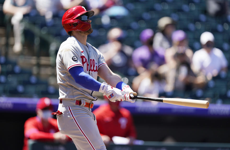 Philadelphia Phillies' Bryce Harper follows the flight of his solo home run off Colorado Rockies starting pitcher Jon Gray in the first inning of a baseball game Sunday, April 25, 2021, in Denver. (AP Photo/David Zalubowski)