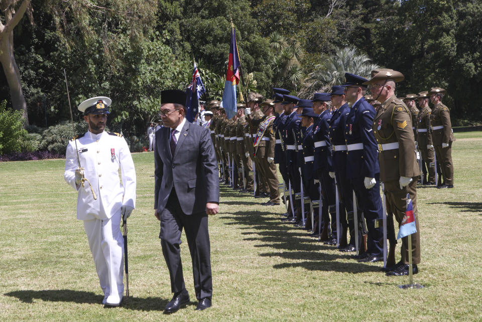 The Prime Minister of Malaysia Anwar Ibrahim walks with Lieutenant Jamie Elters, left, of the Royal Australian Navy as he inspects a Guard of Honor during a ceremonial welcome at Government House ahead the ASEAN-Australia Special Summit in Melbourne, Australia, Monday, March 4, 2024.An increasingly assertive China and a humanitarian crisis in Myanmar are likely to be high on the agenda when Southeast Asian leaders meet in Australia for a rare summit March 4-6. (AP Photo/Hamish Blair)