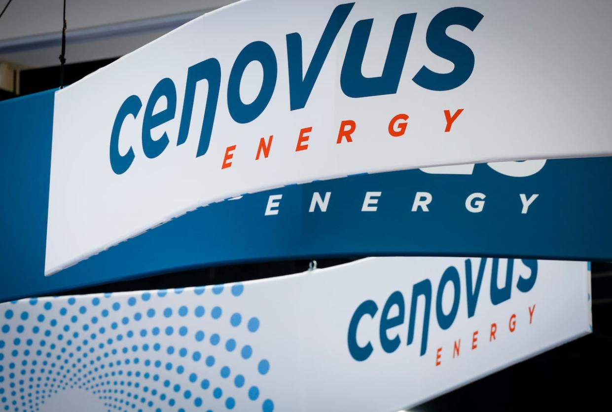 Cenovus Energy logos are on display in a file photo from the Global Energy Show in Calgary in 2022. (Jeff McIntosh/The Canadian Press - image credit)