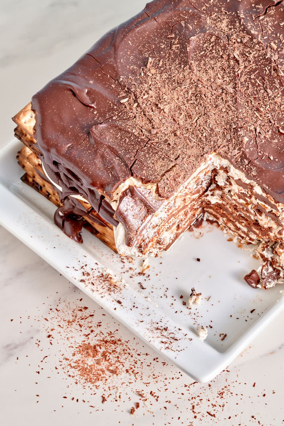 matzo icebox cake with a slice taken out on a white plate