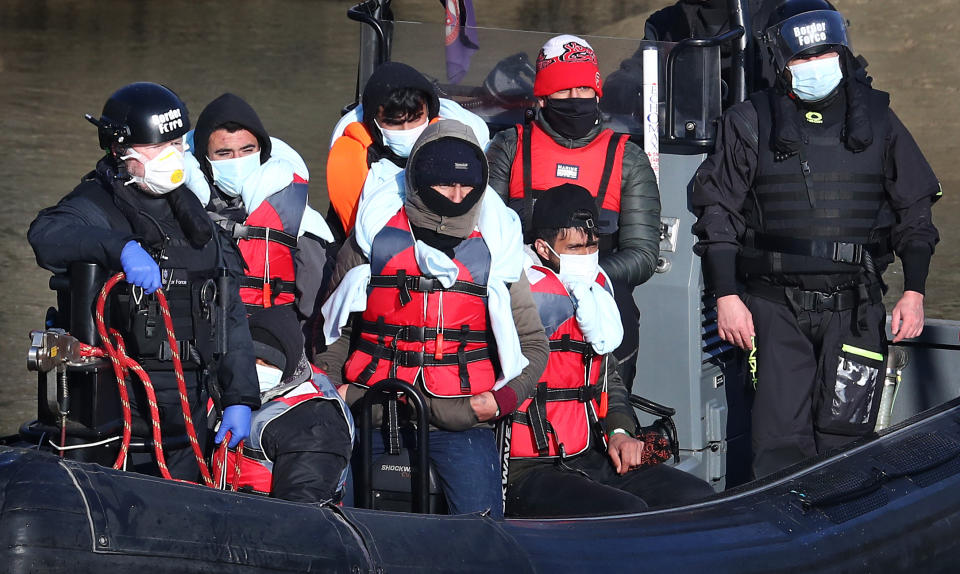 <p>A group of people thought to be migrants are brought in to Dover, Kent, by Border Force officers following a small boat incident in the Channel earlier this morning. Picture date: Tuesday April 13, 2021.</p>
