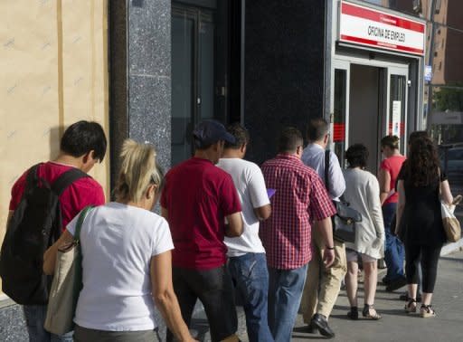People wait in line at a government employment office in the center of Madrid in June. Spain's jobless rate neared 25 percent in June, officials said, darkening the recession outlook despite relief on financial markets at a vow of support by the European Central Bank