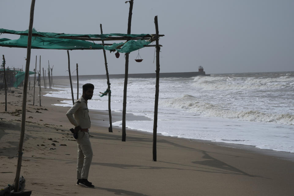 A policeman stands guard on a deserted beach on the Arabia Sea coast at Mandvi in Kutch district of Gujarat state, India, Wednesday, June 14, 2023. With Cyclone Biparjoy expected to make landfall Thursday evening, coastal regions of India and Pakistan are on high alert. (AP Photo/Ajit Solanki)