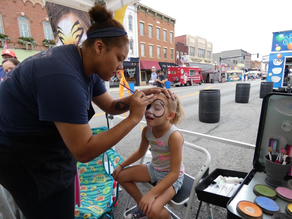 Emmie Makeever, 5, gets her face painted by Tiana Opp during the 2021 Bucyrus Bratwurst Festival.