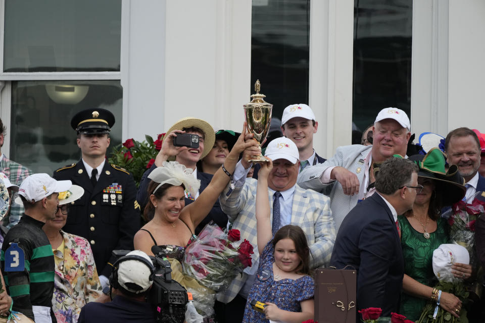 Trainer Kenneth McPeek celebrates with his family after riding Mystik, with jockey Dan Brian Hernandez Jr. won the 150th running of the Kentucky Derby horse race at Churchill Downs Saturday, May 4, 2024, in Louisville, Ky. (AP Photo/Jeff Roberson)