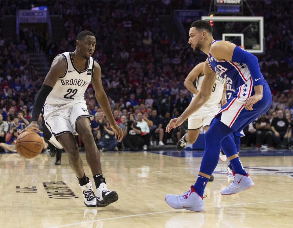 Brooklyn Nets' Caris LeVert, left, makes his move against Philadelphia 76ers' Ben Simmons, right, of Australia, during the second half in Game 5 of a first-round NBA basketball playoff series, Tuesday, April 23, 2019, in Philadelphia. The 76ers won 122-100. (AP Photo/Chris Szagola)