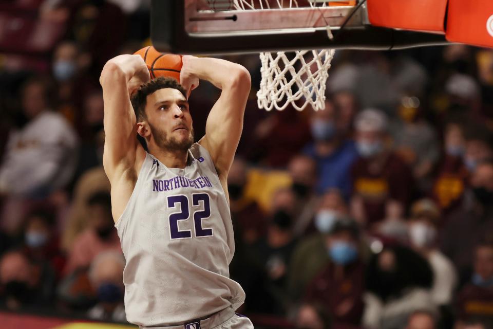 FILE - Northwestern forward Pete Nance (22) goes up to the basket against Minnesota during the second half of an NCAA college basketball game on Feb. 19, 2022, in Minneapolis. Nance says he'll transfer to North Carolina. The 6-foot-10, 225-pound senior announced his commitment to play his fifth year for the Tar Heels in a social-media post Saturday, June 18 2022. (AP Photo/Stacy Bengs, File)