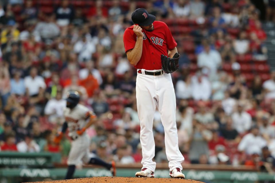 Boston Red Sox's Nathan Eovaldi stands on the mound after giving up a solo home run to Jose Altuve, left, during the third inning of a baseball game, Wednesday, June 9, 2021, in Boston. (AP Photo/Michael Dwyer)