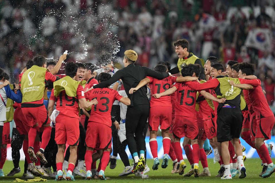 Players of South Korea celebrate after their team's 2-1 victory over Portugal at the end of the World Cup group H soccer match between South Korea and Portugal, at the Education City Stadium in Al Rayyan, Qatar, Friday, Dec. 2, 2022. (AP Photo/Ariel Schalit)