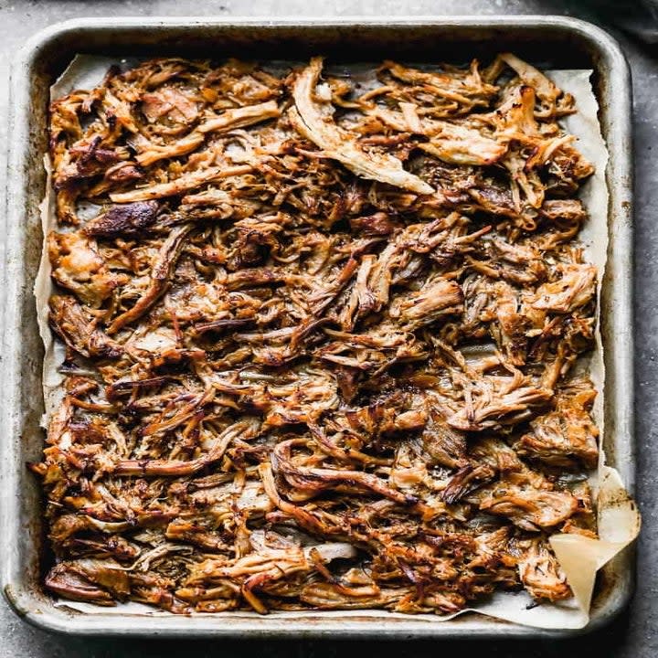 Shredded carnitas on a sheet pan.