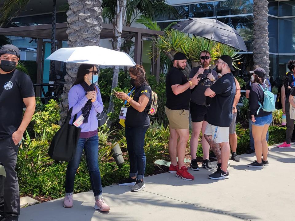 A line of fans holding umbrellas at San Diego Comic-Con 2022.