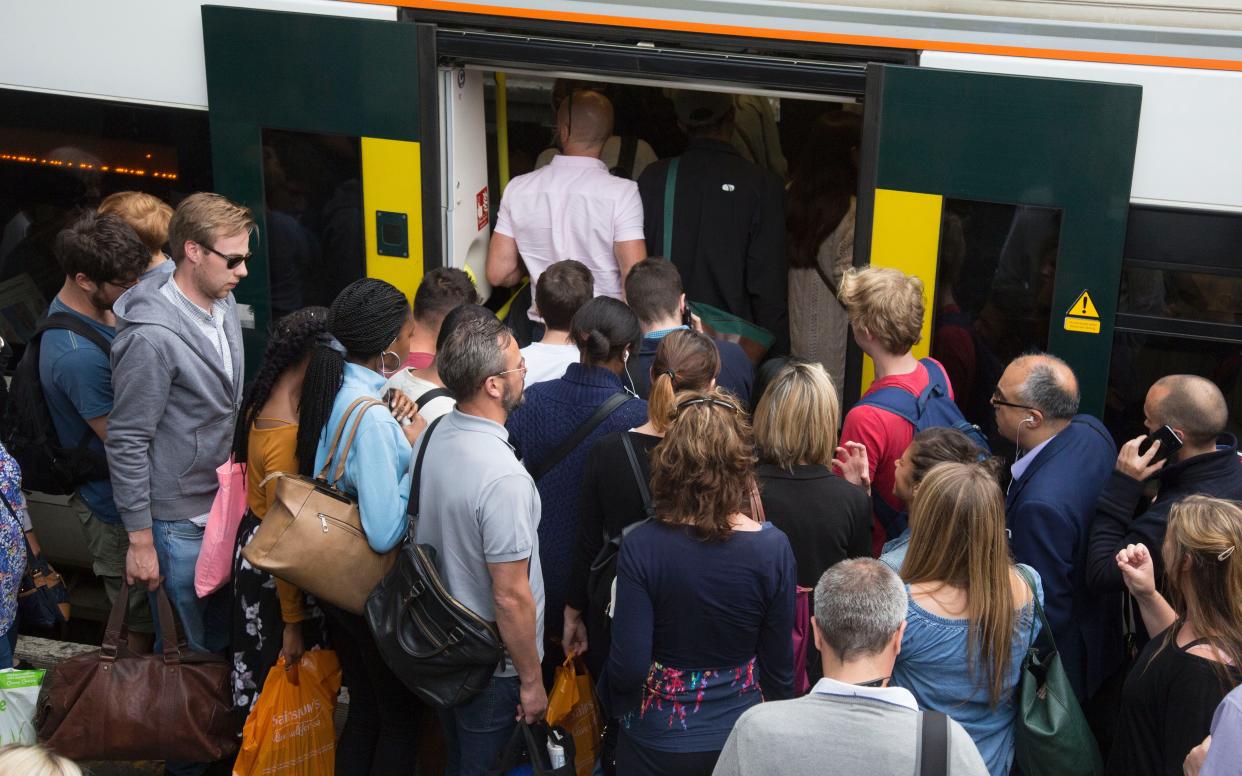 Passengers at Clapham Junction station during rush hour - Nick Edwards