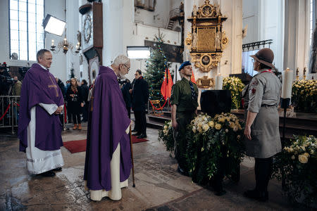 Scouts and clergy members stand near the remains of the city's mayor Pawel Adamowicz during his funeral service at St Mary's Basilica in Gdansk, Poland January 19, 2019. Agencja Gazeta/Bartosz Banka via REUTERS