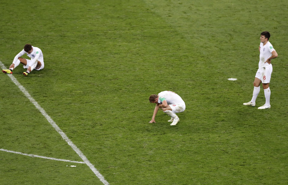 England players react on the pitch (AP Photo/Darko Bandic)