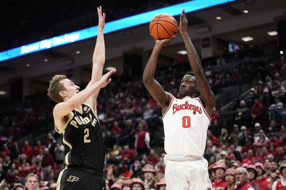 Feb 18, 2024; Columbus, Ohio, USA; Ohio State Buckeyes guard Scotty Middleton (0) shoots over Purdue Boilermakers guard Fletcher Loyer (2) during the NCAA men’s basketball game at Value City Arena. Ohio State won 73-69.