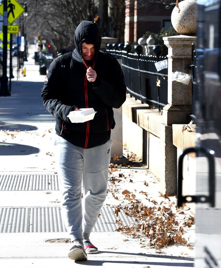 WORCESTER - Clark University freshman Pietro Briguglio of Italy pulls his hoodies' drawstrings tighter while walking on Main Street on Friday.