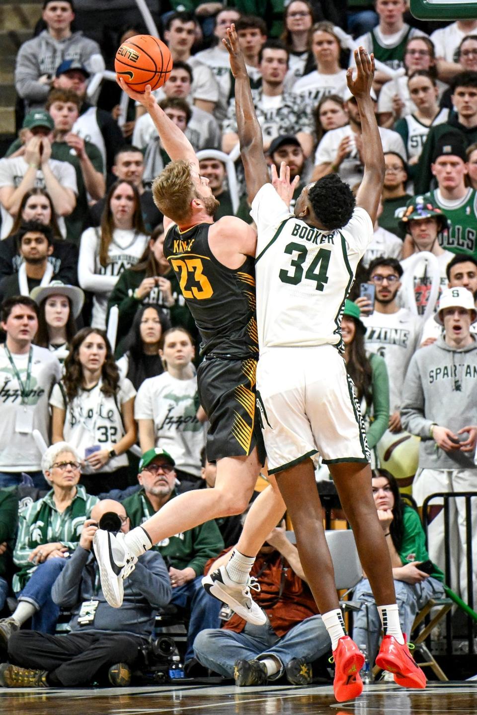 Michigan State's Xavier Booker, right, pressures Iowa's Ben Krikke on a shot during the first half on Tuesday, Feb. 20, 2024, at the Breslin Center in East Lansing.