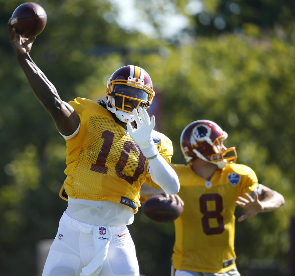 Things got tense for the Washington Redskins with quarterbacks Robert Griffin III, left, and Kirk Cousins. (AP) 