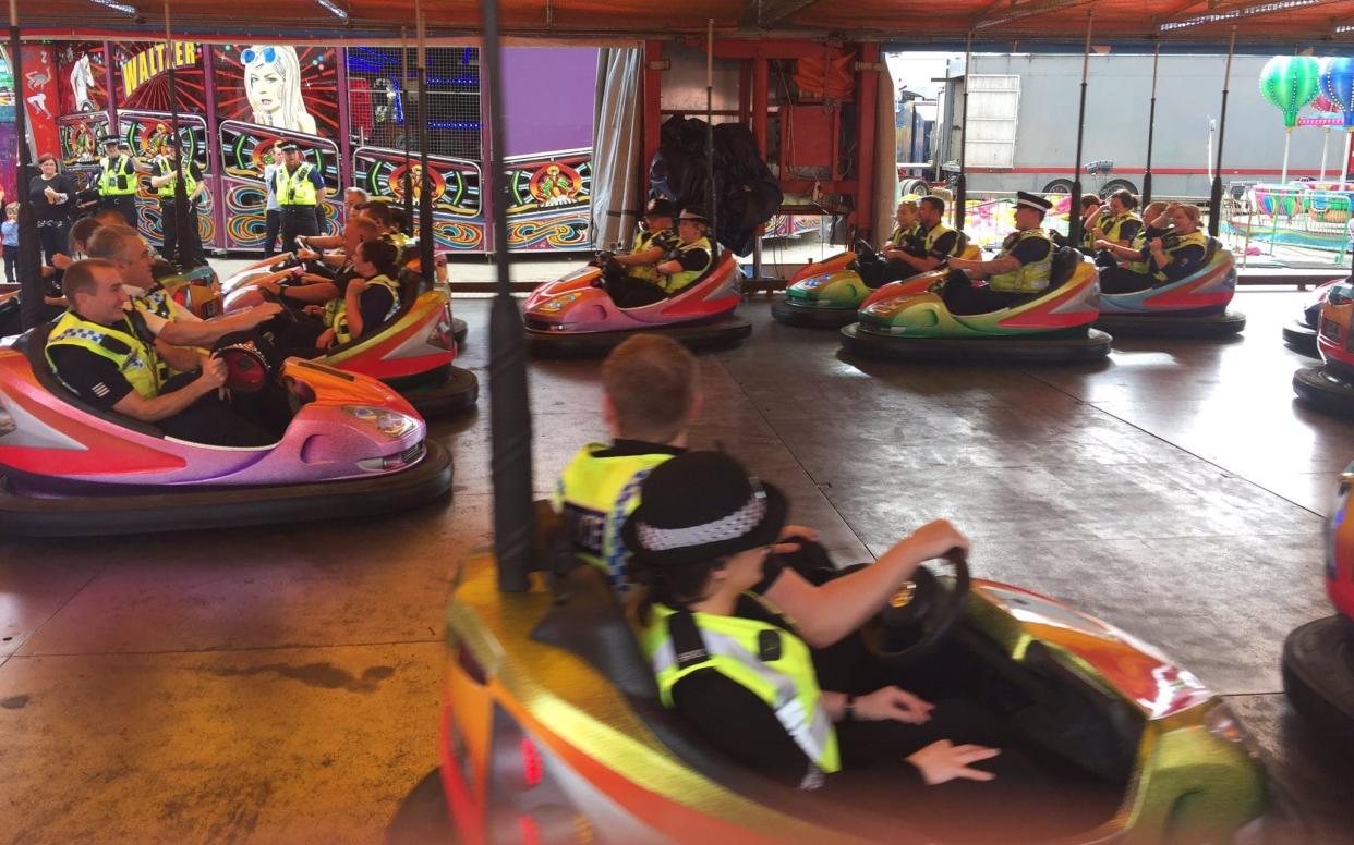 Inspector Scott Snowden‏ posted this picture with the caption: 'More Cops having a bit of well earned fun with people at the fair!' - @InspSSnowden/Twitter