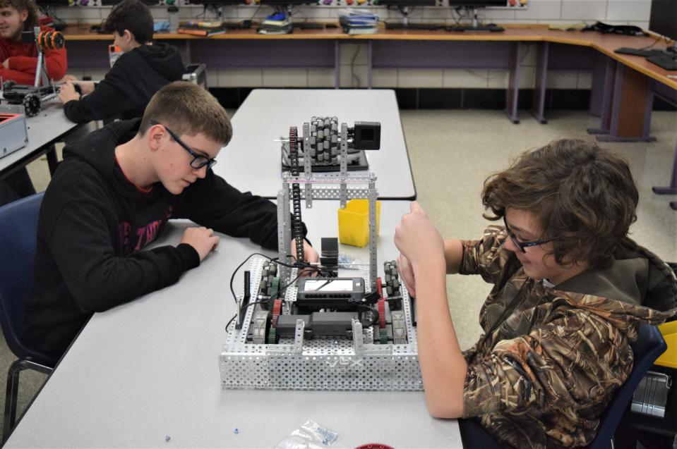 West Holmes Middle School students Boden Macaulay (left) and Blake Harford work on their Vex robot.