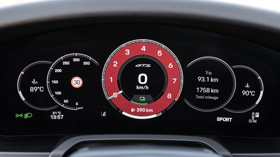 A close-up of the digital instrument cluster in a hybrid Porsche 911 Carrera GTS.