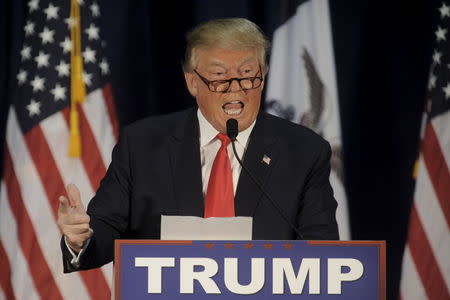 U.S. Republican presidential candidate Donald Trump reads the lyrics of Al Wilson's "The Snake" at a campaign event at University of Northern Iowa in Cedar Falls, Iowa January 12, 2016. REUTERS/Mark Kauzlarich