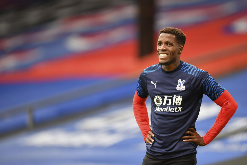 Crystal Palace's Wilfried Zaha warms up prior of the English Premier League soccer match between Crystal Palace and Burnley at Selhurst Park, in London, England, Tuesday, July 7, 2020. (Justin Tallis/Pool via AP)