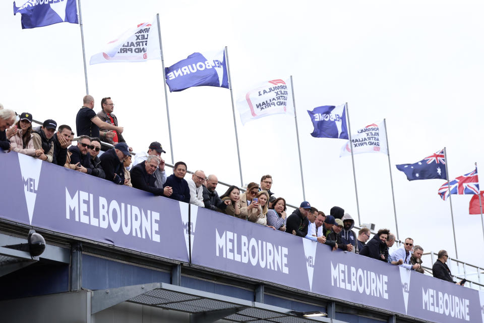 Fans look onto pit lane as teams prepare for a practice session ahead of the Australian Formula One Grand Prix at Albert Park in Melbourne, Saturday, April 1, 2023. (AP Photo/Asanka Brendon Ratnayake)